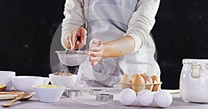 Woman staining flour in sieve 4k