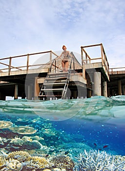 Woman on the stairs at descent to the sea and a under water view