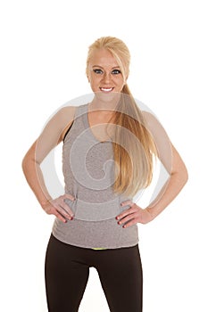 Woman stand hands hips gray tank top smile