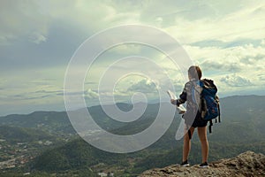 Woman stand on the mountain with travel and adventure concept.