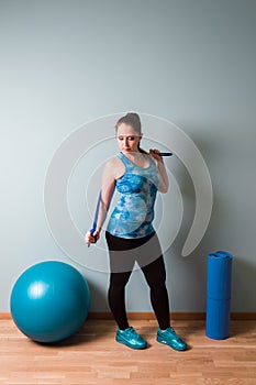 Woman stand with quipment for fitness or yoga in the room