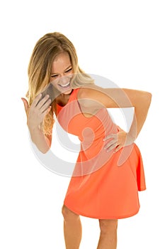 Woman stand in red dress bend over laughing