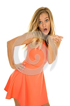 Woman stand in red dress hand on hip mouth open