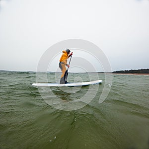 Woman on a stand up paddle