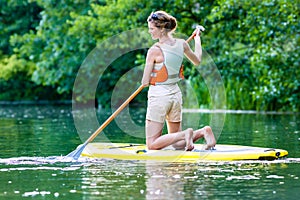 Woman with stand up paddle board sup on river