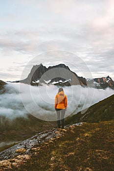 Woman standing alone in mountains travel adventure lifestyle outdoor
