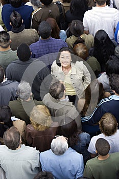 Woman Standing Amidst Around The People