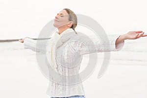 Woman standing with arms open wide