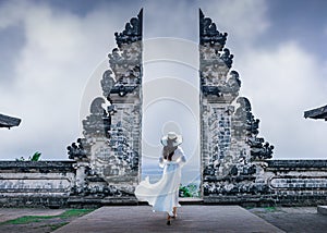 Woman standing in Bali gate at Pura Luhur Lempuyang temple Bali,Indonesia