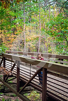 Woman standing on bridge in Autumn