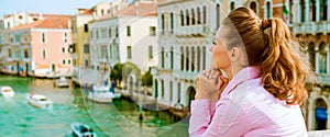 Woman standing on bridge with grand canal view in ve