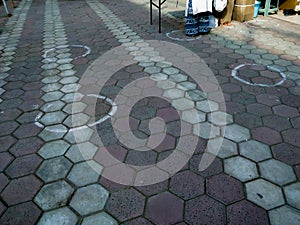 Woman standing in the circle made for maintaining social distance