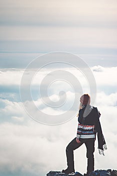 Woman standing on cliff alone thinking