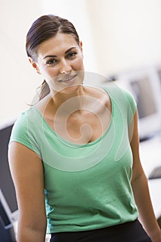 Woman standing in computer room smiling