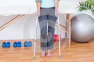 Woman standing with crutch