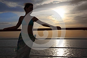 Woman standing on deck of cruise ship