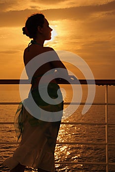 Woman standing on deck of cruise ship