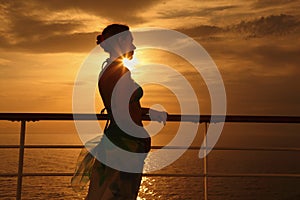 Woman standing on deck of cruise ship