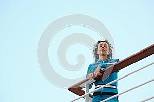 Woman is standing on deck of cruised ship