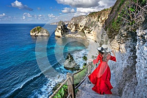 Woman standing on Diamond beach in Nusa penida island, Bali in Indonesia.