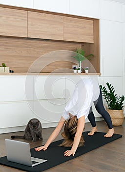 Woman standing in a downward-facing dog pose photo