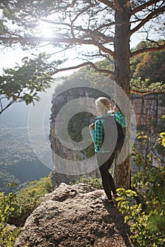 Woman standing on the edge of canyon.