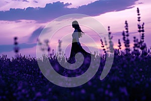 a woman is standing in a field of purple flowers at sunset