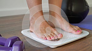 Woman standing on fitness scale