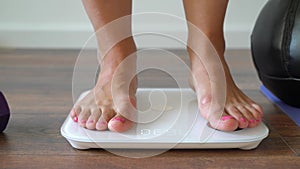 Woman standing on fitness scale