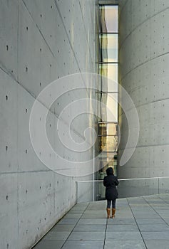 Woman is standing in front of a narrow window at the Paul Loebe house in Berlin`s government district