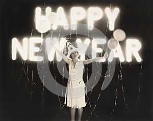 Woman standing in front of neon Happy New Year sign photo