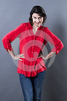Woman standing with hands on hips expressing happy self-confidence