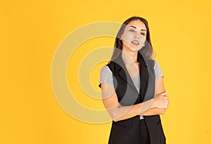 The woman is standing with her arms crossed and smiling. There is space to put messages. In the yellow background