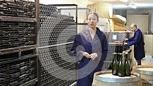 Woman standing indoors on small wine manufacturing