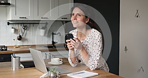 Woman standing in kitchen hold smartphone enjoy pleasant online chat