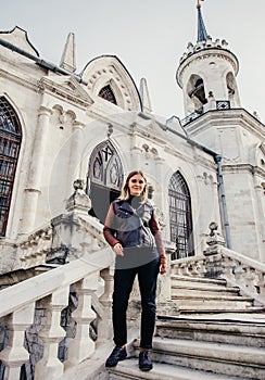 Woman standing on large stone staircase old historical temple fortress building church