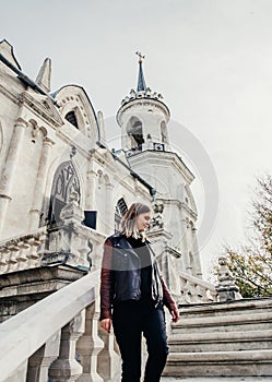 Woman standing on large stone staircase old historical temple fortress building church