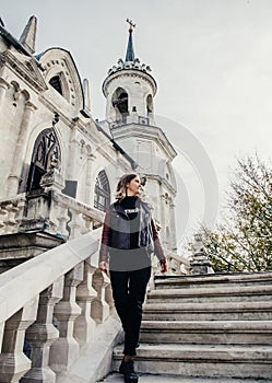 Woman standing on large stone staircase old historical temple fortress building church