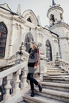 Woman standing on large stone staircase old historical temple fortress building church