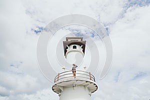 Woman standing on lighthouse in Baan Bang Bao fisherman village on Koh Chang island, Thailand