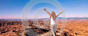 Woman standing and looking at sunset Gorafe desert