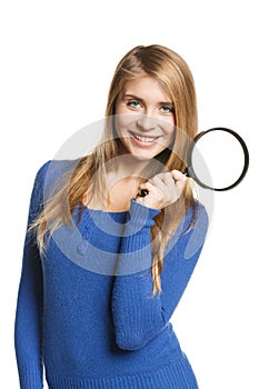 Woman standing with magnifying glass