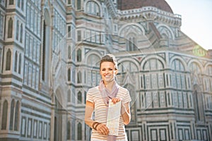 Woman standing with map in florence, italy