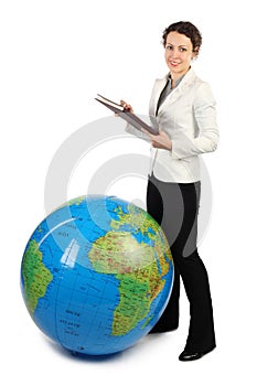 Woman standing near big inflatable globe