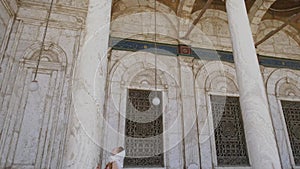 Woman is standing near column at the Great Mosque of Muhammad Ali Pasha.