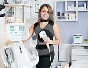 Woman standing near equipments in professional salon.