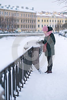 A woman standing near Griboedov Canal at winter, Sankt Petersburg, Russia.