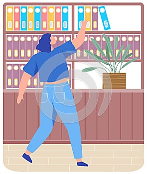 Woman standing near shelf with books and archive folders searching for book on bookshelf in office