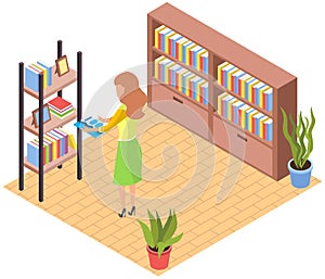 Woman standing near shelf with photo frames and books searching for book on bookshelf at home