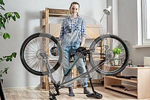 Woman is standing next to a bicycle that is about to be disassembled for maintenance